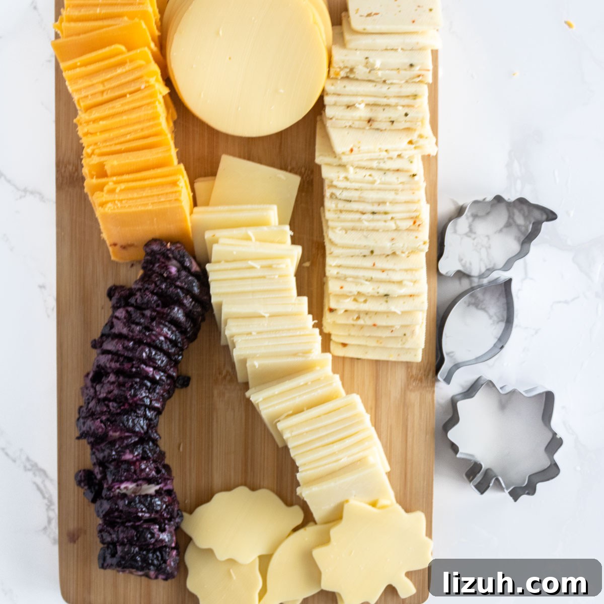 Different types of cheeses on a cutting board.