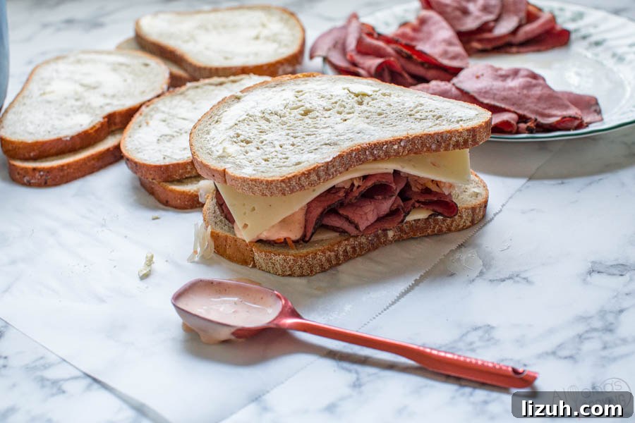 buttered slices of rye bread about to be grilled to make a homemade reuben sandwich recipe