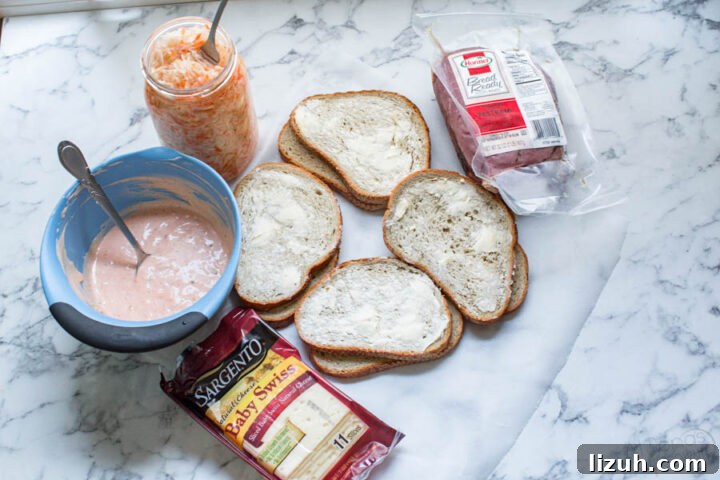 how to make a reuben sandwich with pastrami, swiss cheese, homemade sauerkraut, thousand island dressing over rye bread