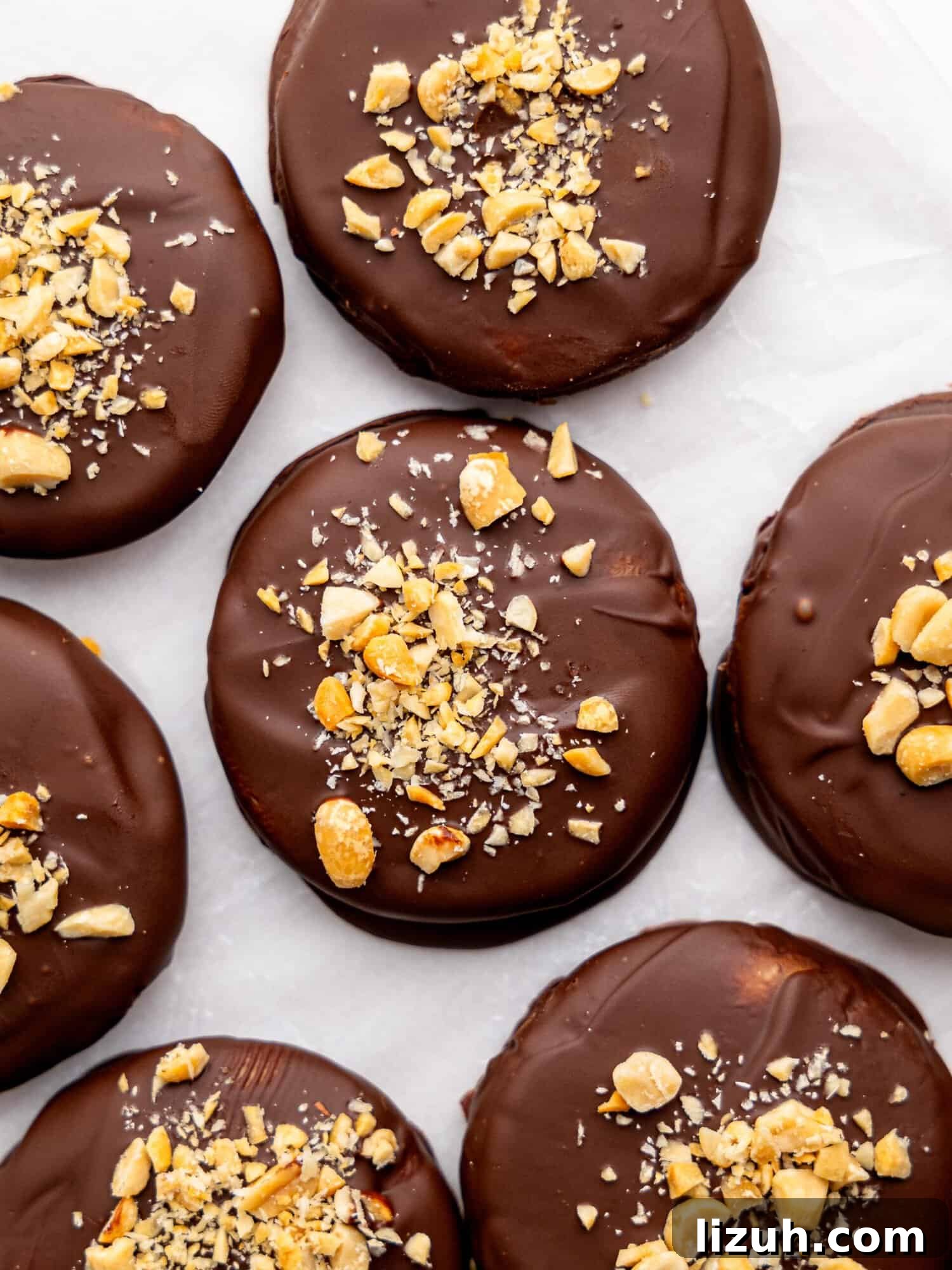 No bake peanut butter cookies on a sheet of parchment paper.