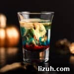 Alien brain hemorrhage shot with glowing pumpkins in the background.