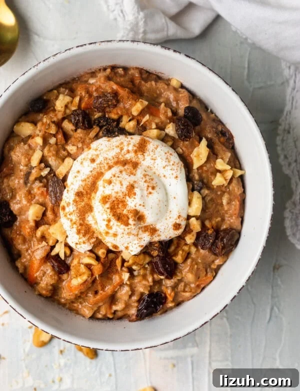 carrot cake oatmeal in a bowl topped with Greek yogurt and cinnamon