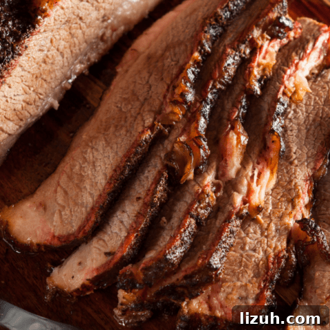 Cooked Brisket Slices on Wooden Board