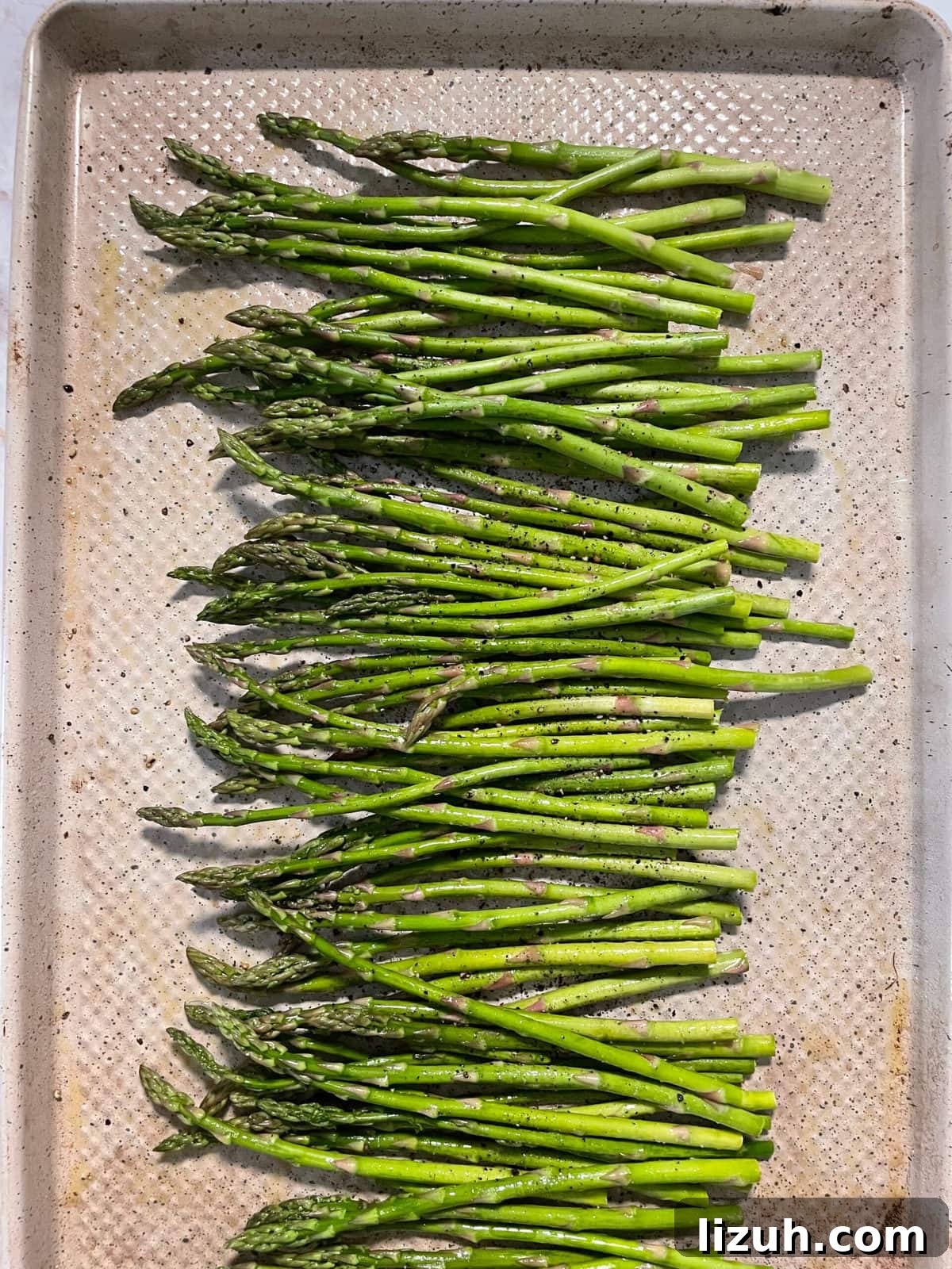 asparagus on sheet pan with salt and pepper