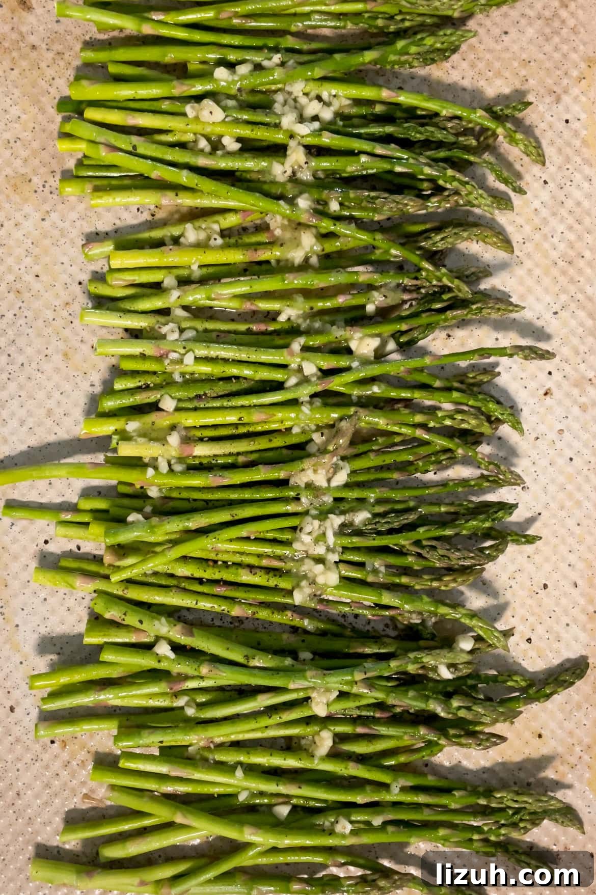 asparagus on sheet pan with honey lemon butter sauce