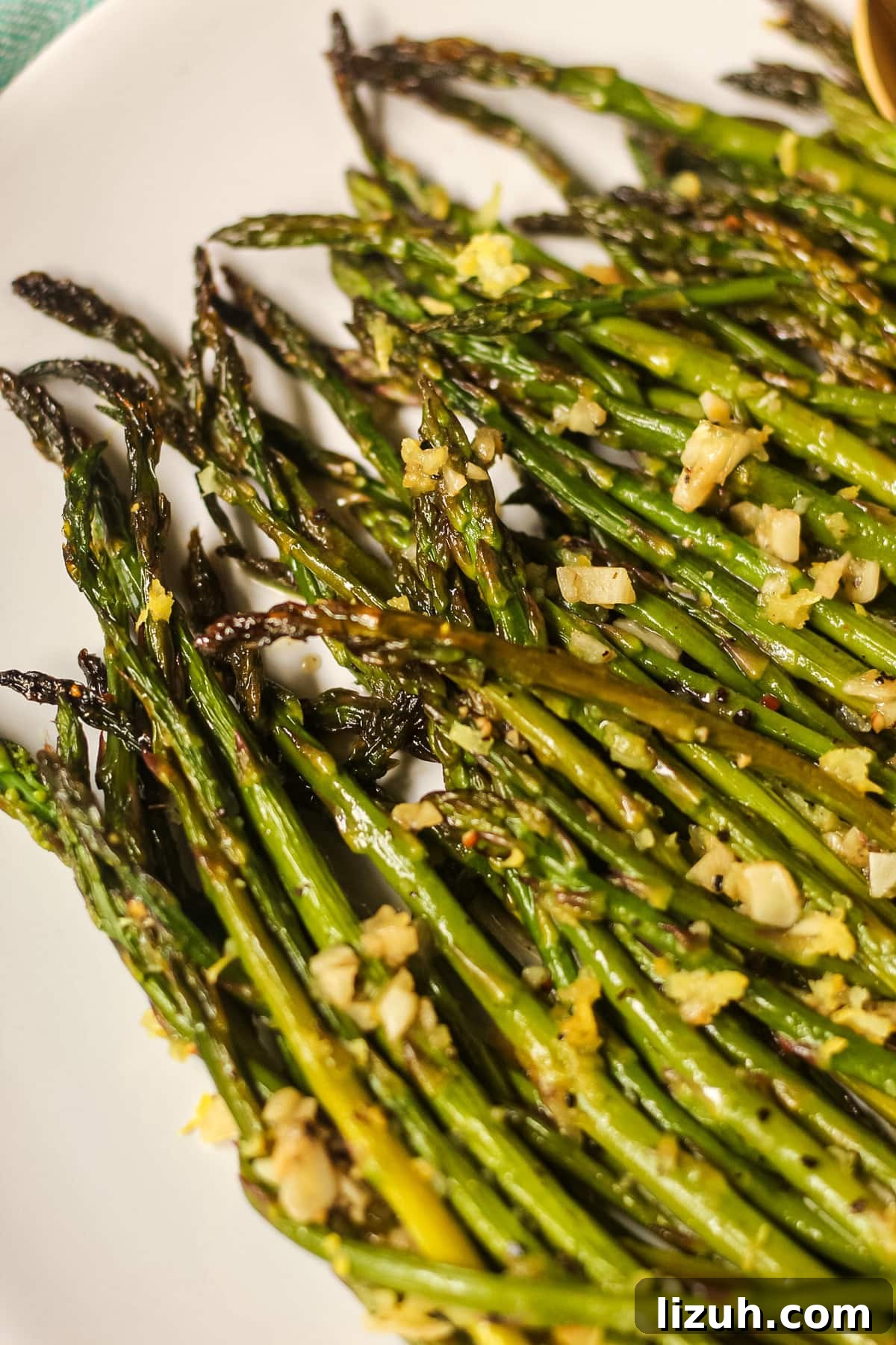 honey lemon butter roasted asparagus on a white plate