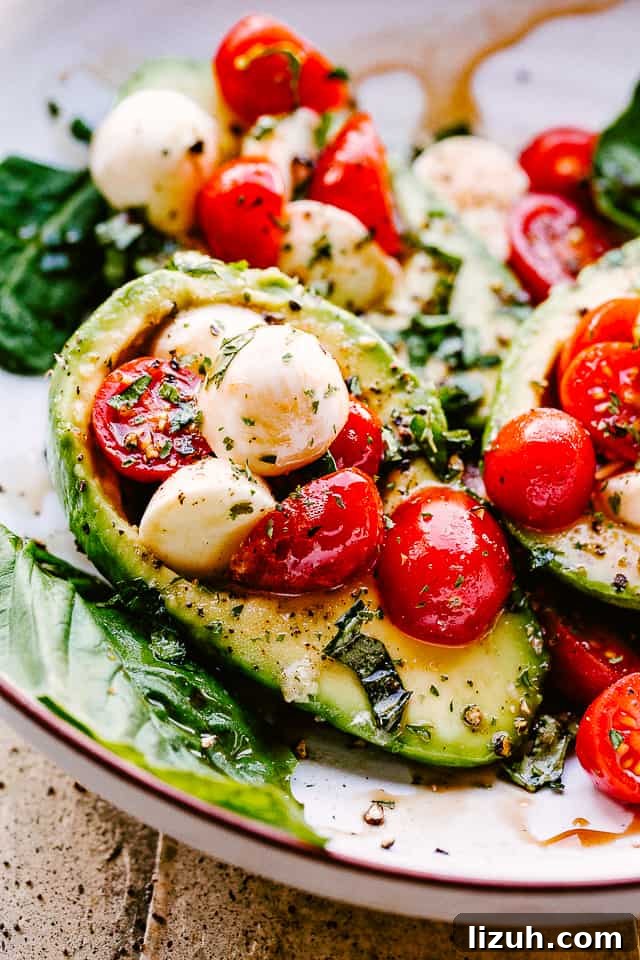 Caprese-Stuffed Avocados: Fresh Tomato, Mozzarella & Basil Recipe 2 Caprese Stuffed Avocados served on a plate