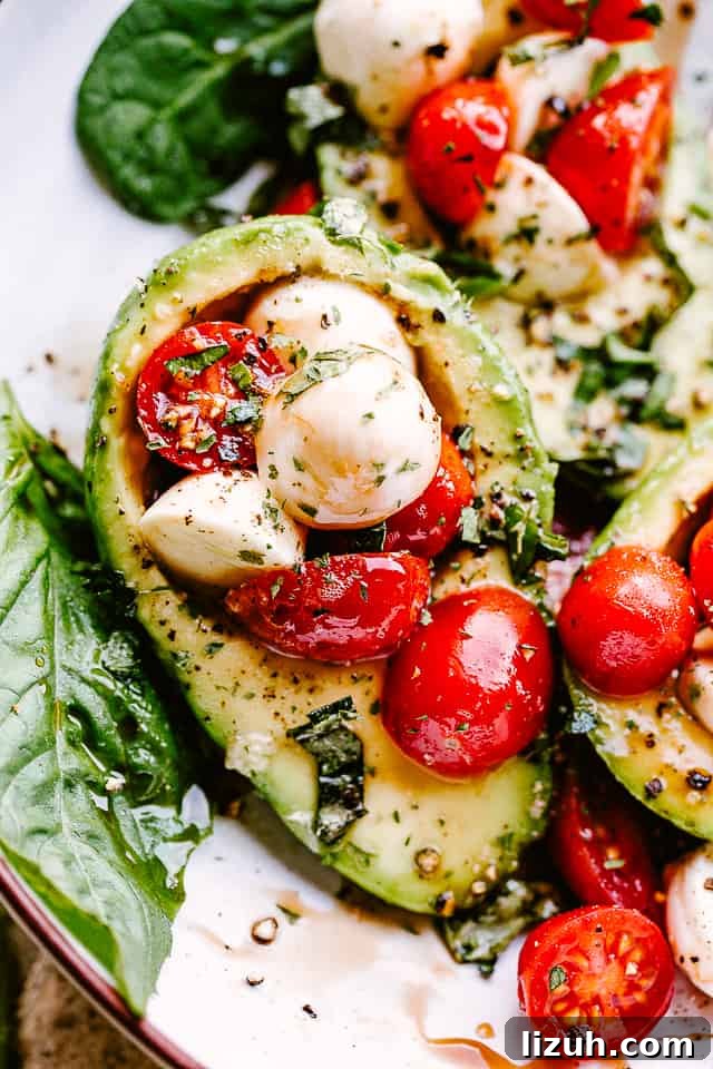 Caprese-Stuffed Avocados: Fresh Tomato, Mozzarella & Basil Recipe 5 close up shot of Caprese Stuffed Avocados