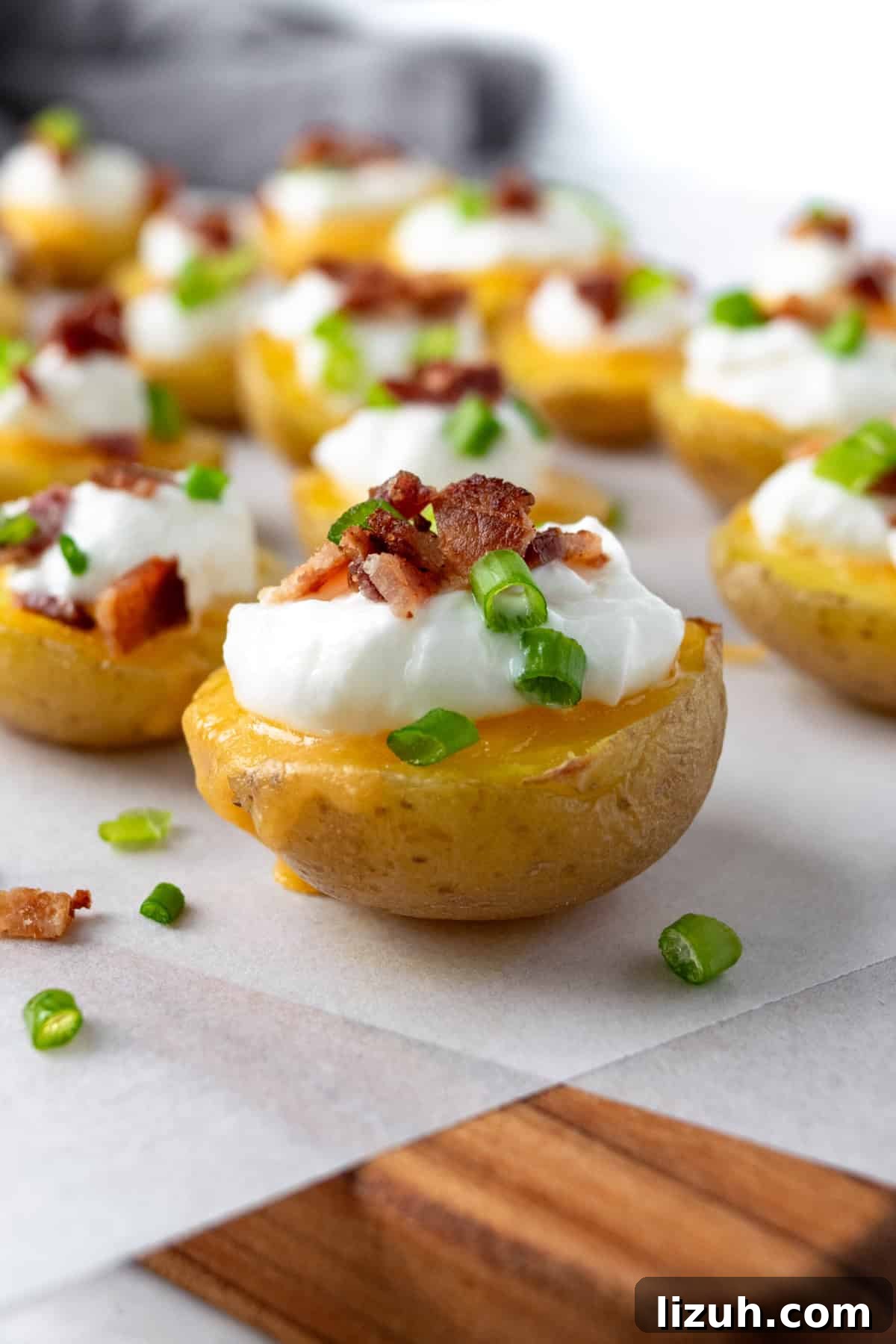 Crispy Baked Potato Bites with Garlic Herb Dip 2 Baked Potato Bites topped with greek yogurt, bacon, and green onion.