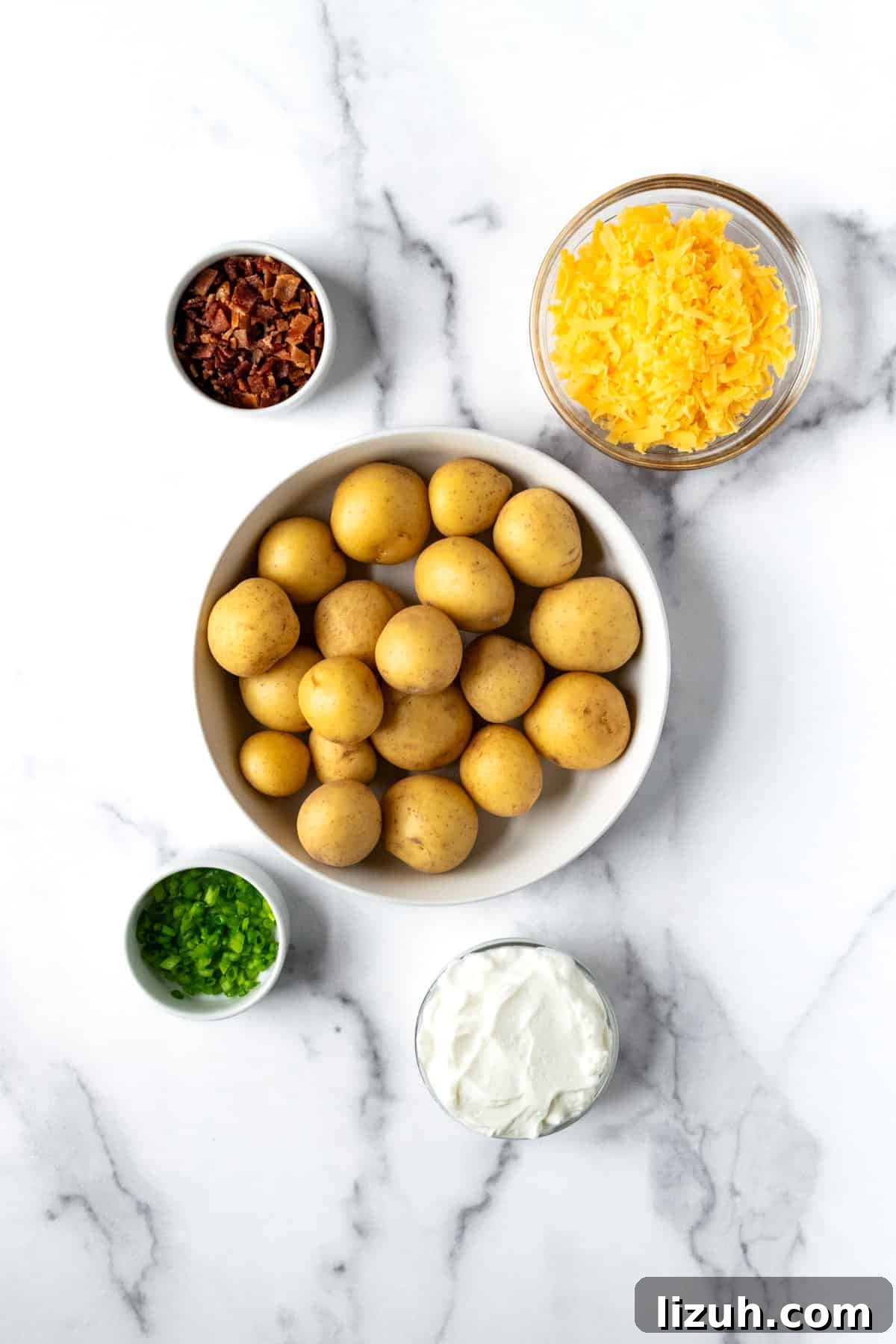 Crispy Baked Potato Bites with Garlic Herb Dip 3 Baked Potato Bites Ingredients on a marble countertop.