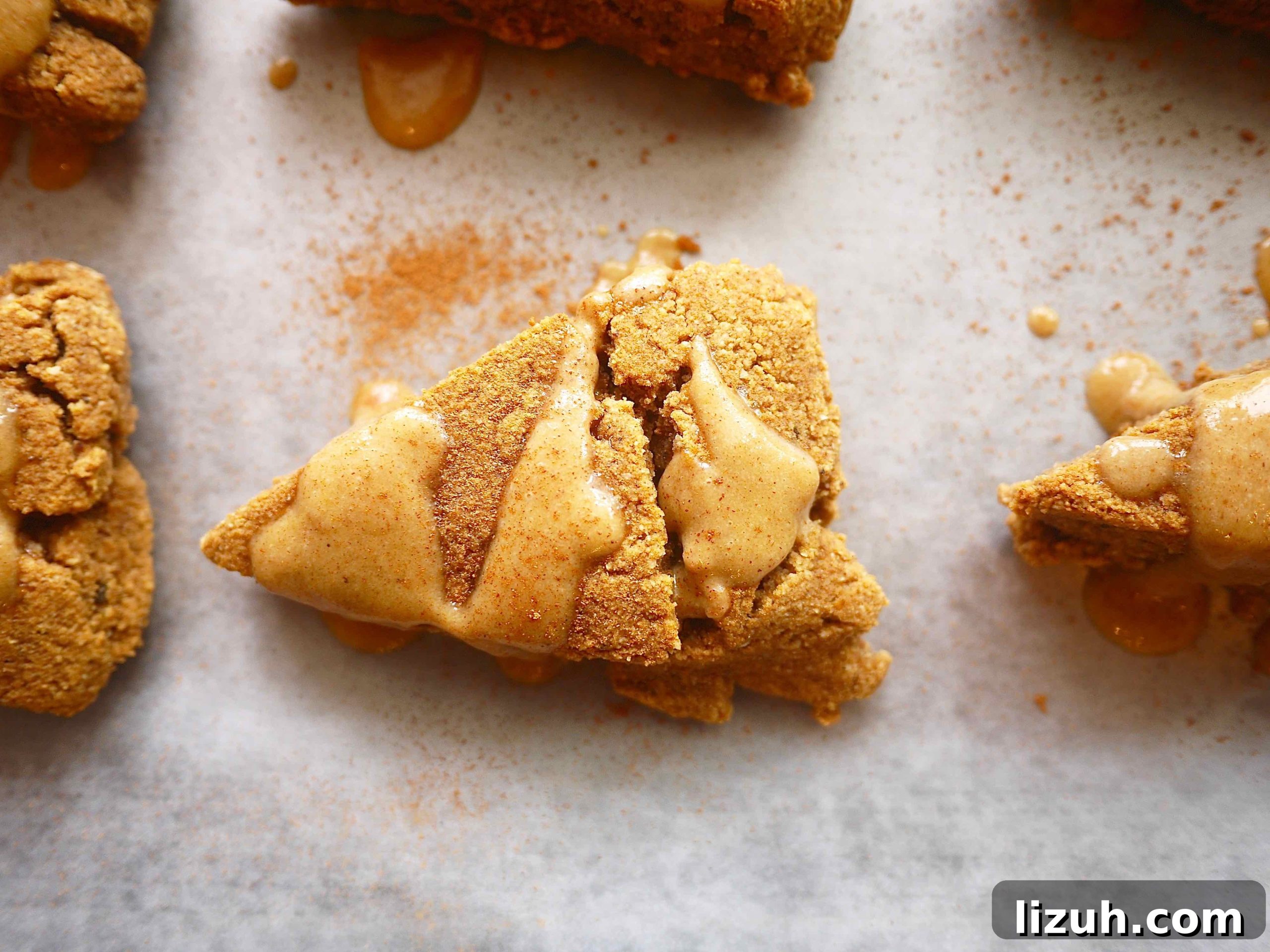 Pumpkin gluten-free scones with frosting on top.