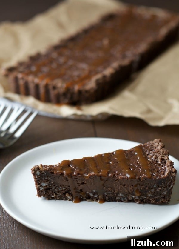 Gluten-Free Chocolate Tart with Salted Caramel Drizzle 3 Gluten Free Chocolate Caramel Tart slice on a plate.
