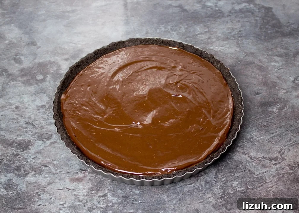 Halloween Chocolate Tart with Bloody Spiderweb Decoration 9 Dark chocolate ganache poured over the Oreo crust in a fluted tin