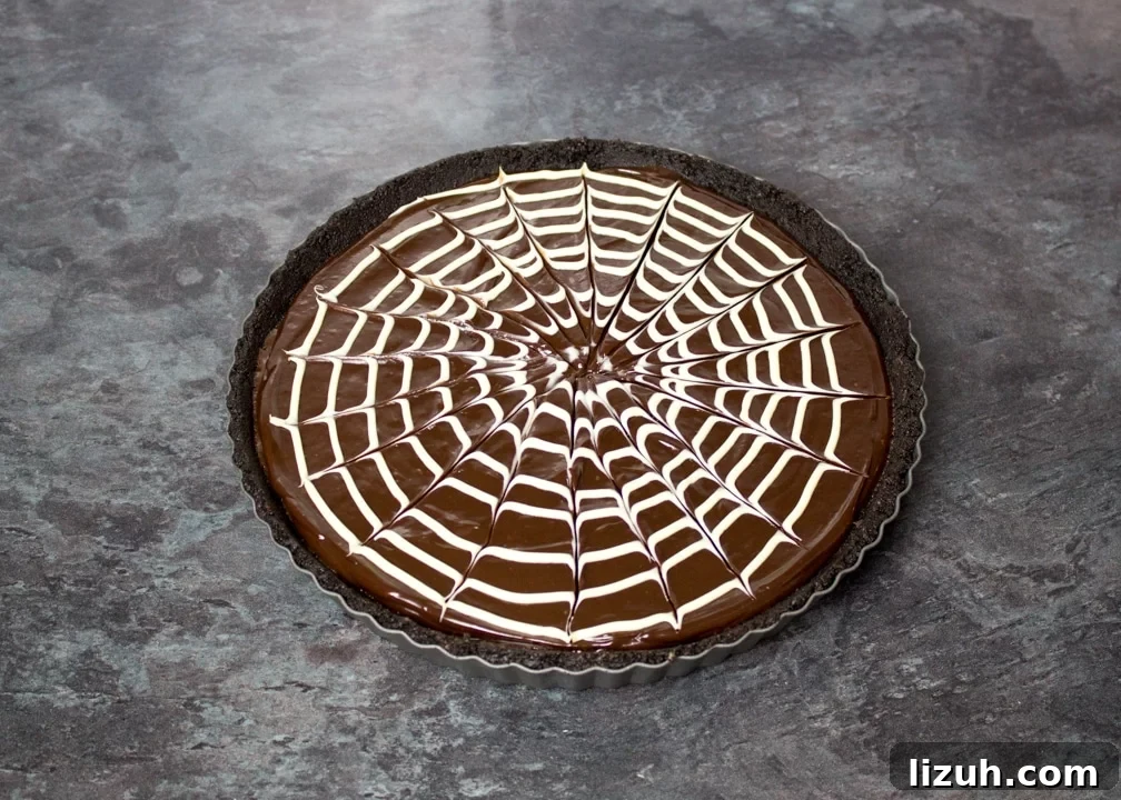 Halloween Chocolate Tart with Bloody Spiderweb Decoration 11 White chocolate spider web pattern skewered on top of a chocolate tart