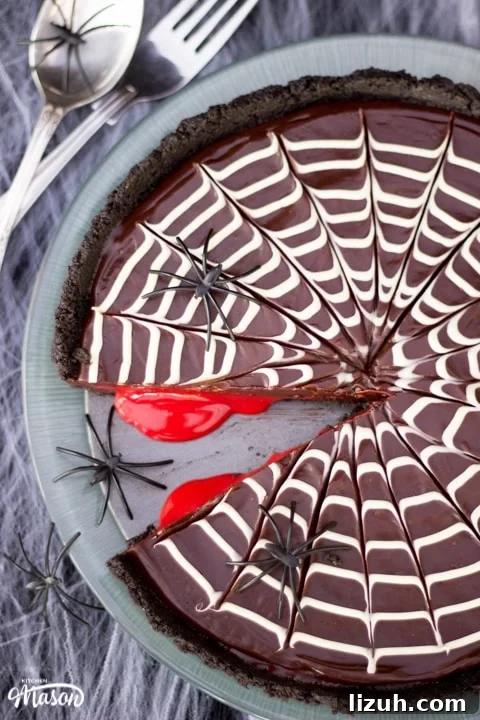 Halloween Chocolate Tart with Bloody Spiderweb Decoration 2 Halloween Dessert | No Bake Bloody Spider Web Chocolate Tart on a plate with plastic spiders