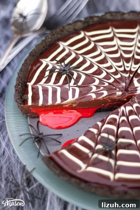 Halloween Chocolate Tart with Bloody Spiderweb Decoration 4 Halloween Dessert | No Bake Bloody Spider Web Chocolate Tart on a plate with plastic spiders
