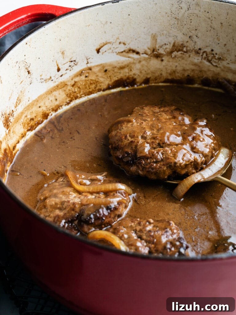 hamburger steaks with onion gravy in a dutch oven