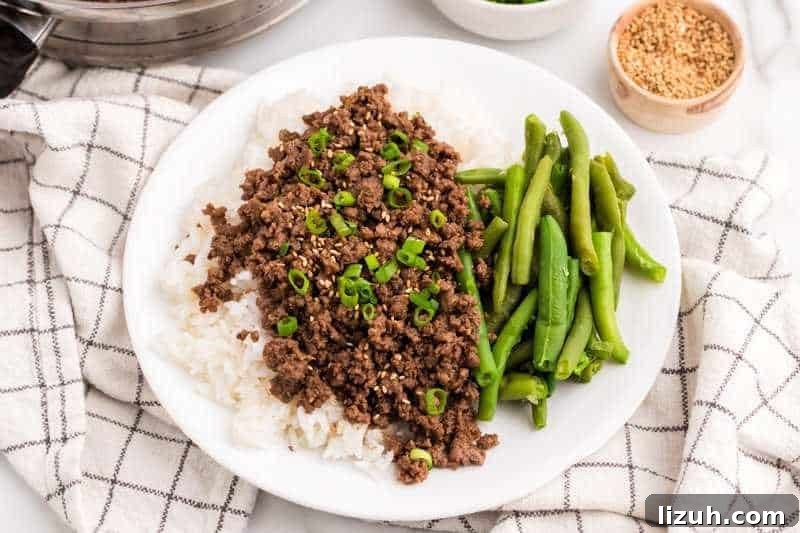 Asian Ground Beef served on a bed of rice.