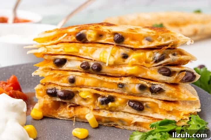 Black Bean Quesadillas stacked on a plate.