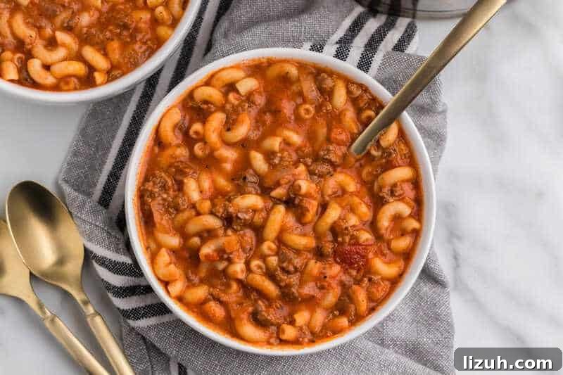 Beef and Macaroni Soup served in a white bowl.