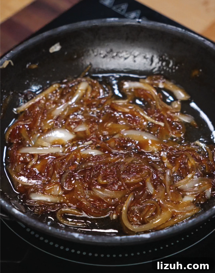 How to Make a Juicy Smash Burger at Home 4 Sliced onions cooked with soy sauce, sesame oil, and sugar until jammy and golden, creating the sweet-savory topping for the Asian Smash Burger.