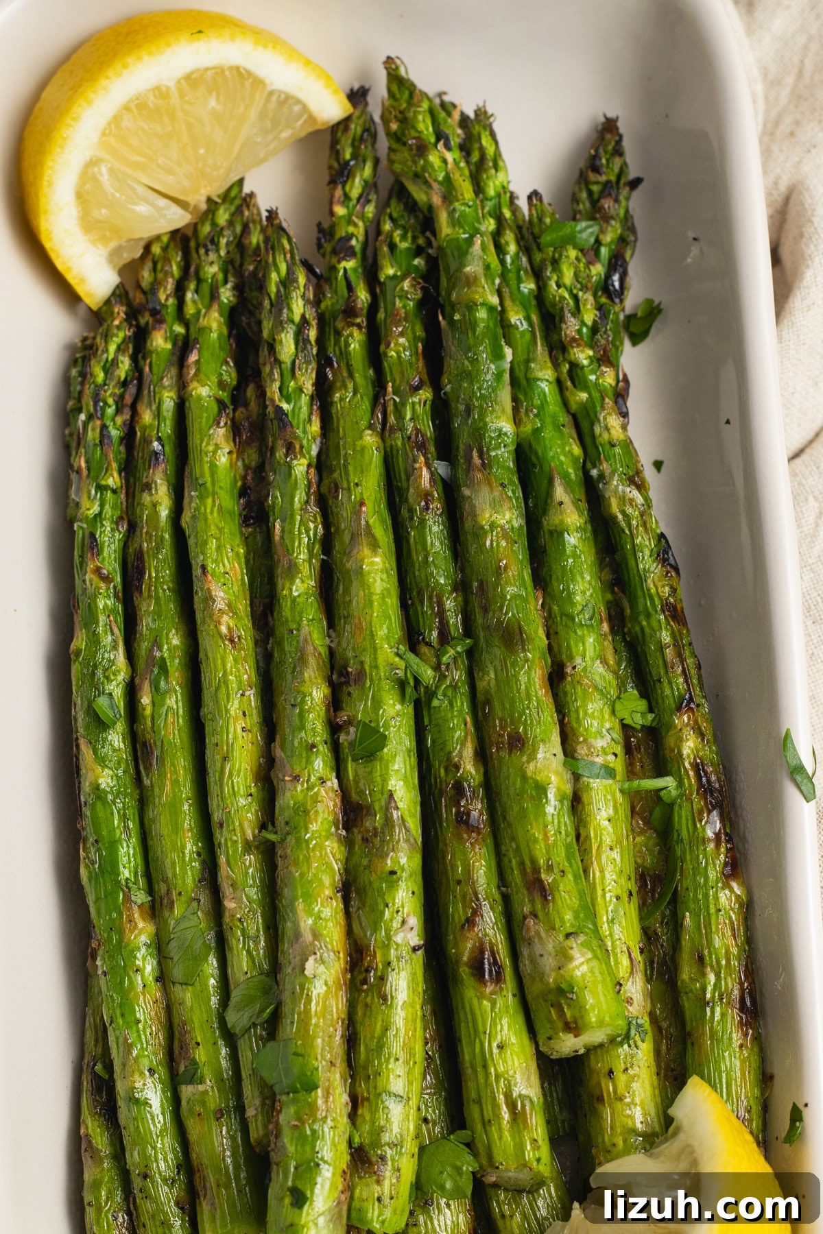 This is a picture of a dish filled with grilled asparagus.