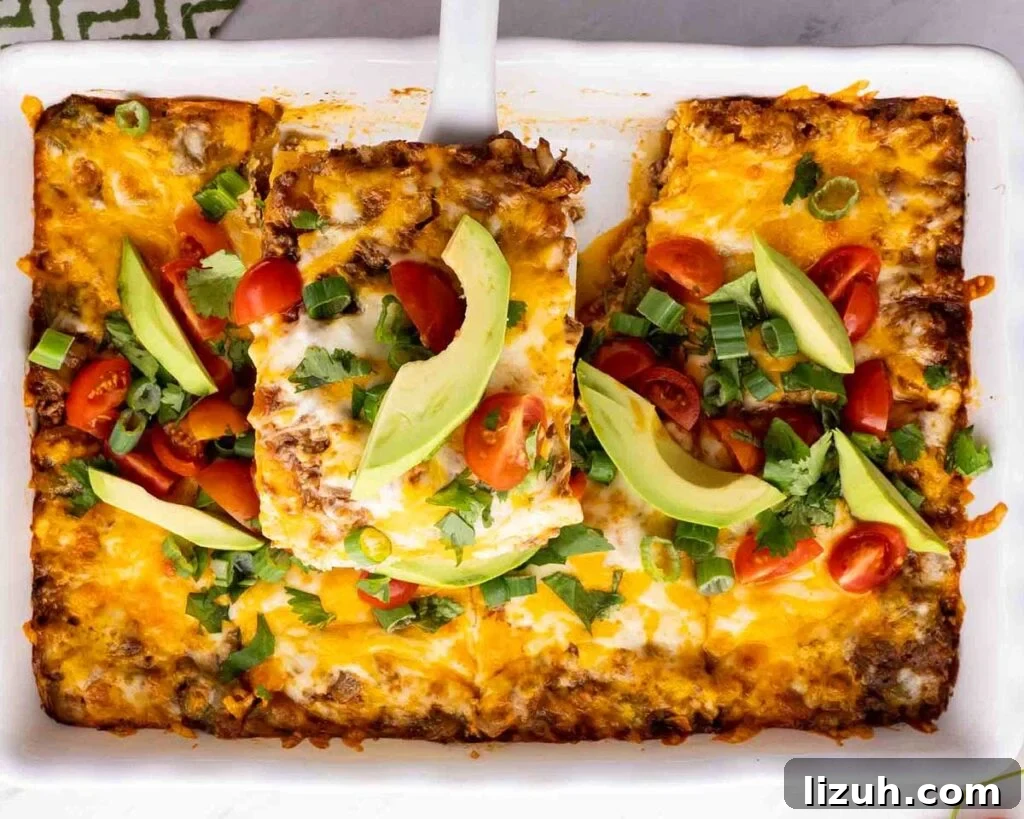 27 Delicious Taco Recipes for Any Night of the Week 14 A serving of taco lasagna being lifted from a casserole dish.