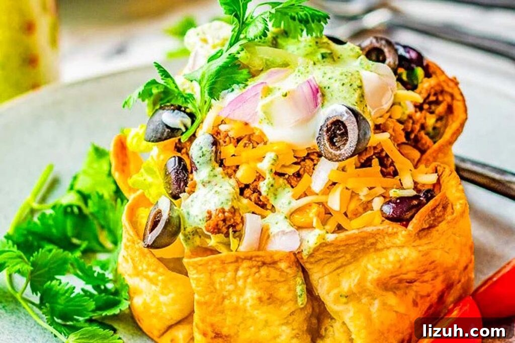 27 Delicious Taco Recipes for Any Night of the Week 15 A taco salad bowl on a plate.