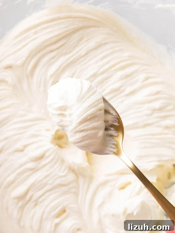 A spoon of thick rich and creamy Cream Cheese Frosting