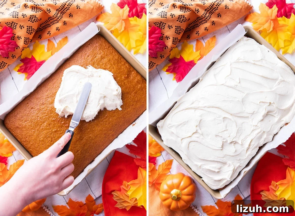 spreading cream cheese frosting over the best pumpkin cake before slicing