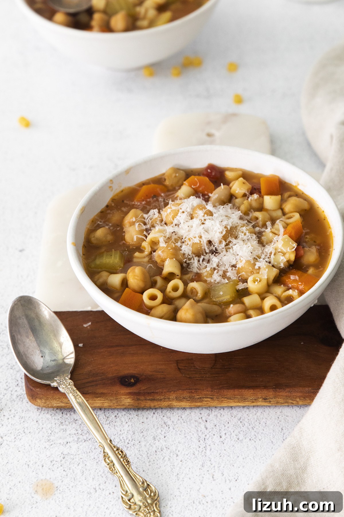Creamy Chickpea Soup Recipe for Cozy Weeknight Meals 2 side view of a bowl filled with chickpea soup next to a spoon