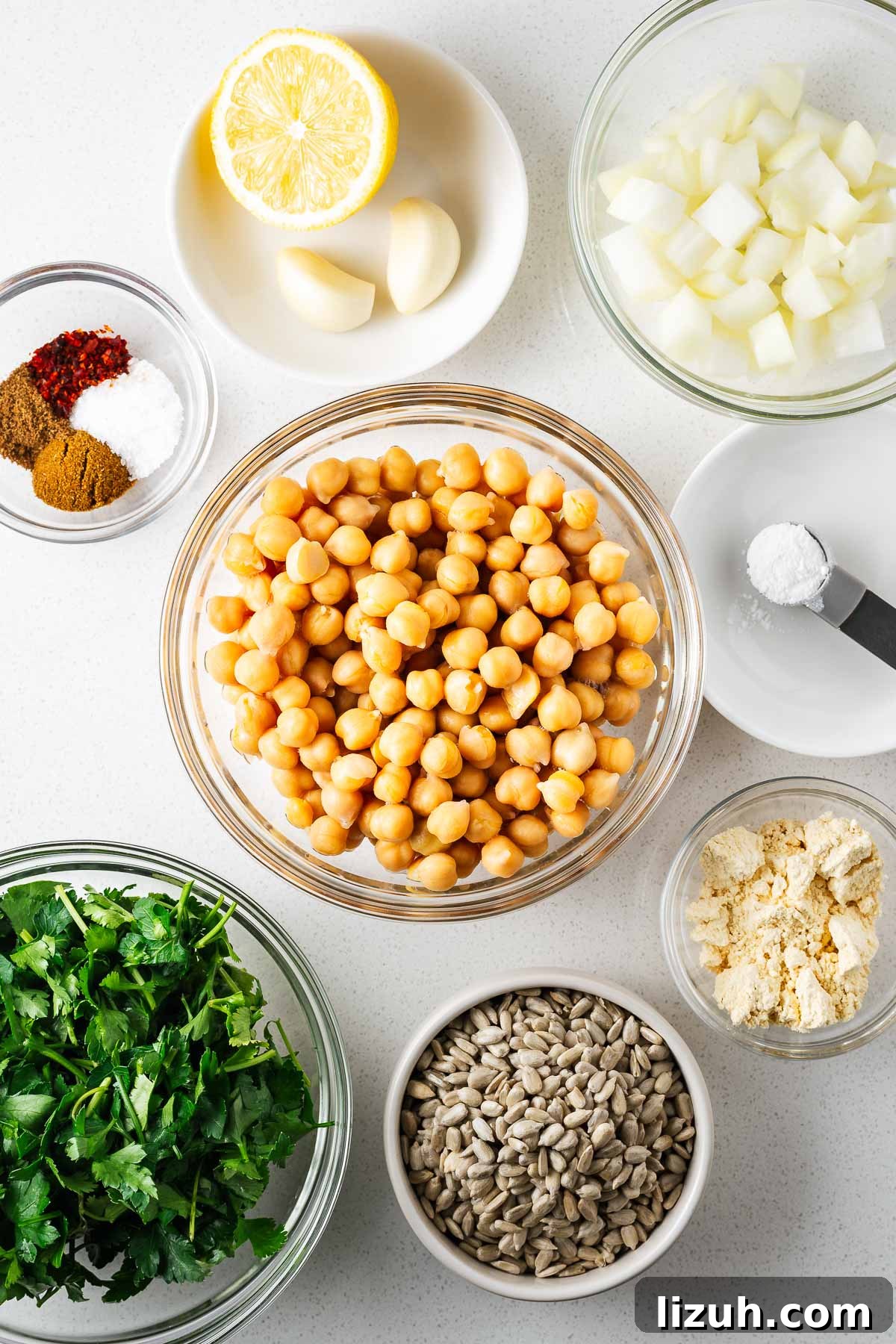 Crispy Oven-Baked Falafel Using Canned Chickpeas 4 Ingredients for the baked falafel recipe using canned chickpeas arranged on a white kitchen counter viewed from above.