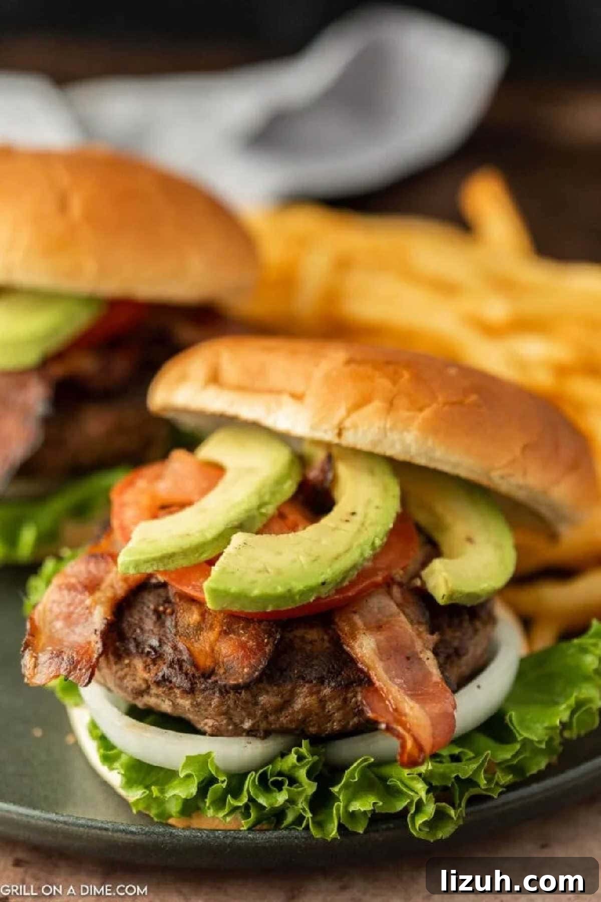 Avocado Bacon Burger with French Fries in the background