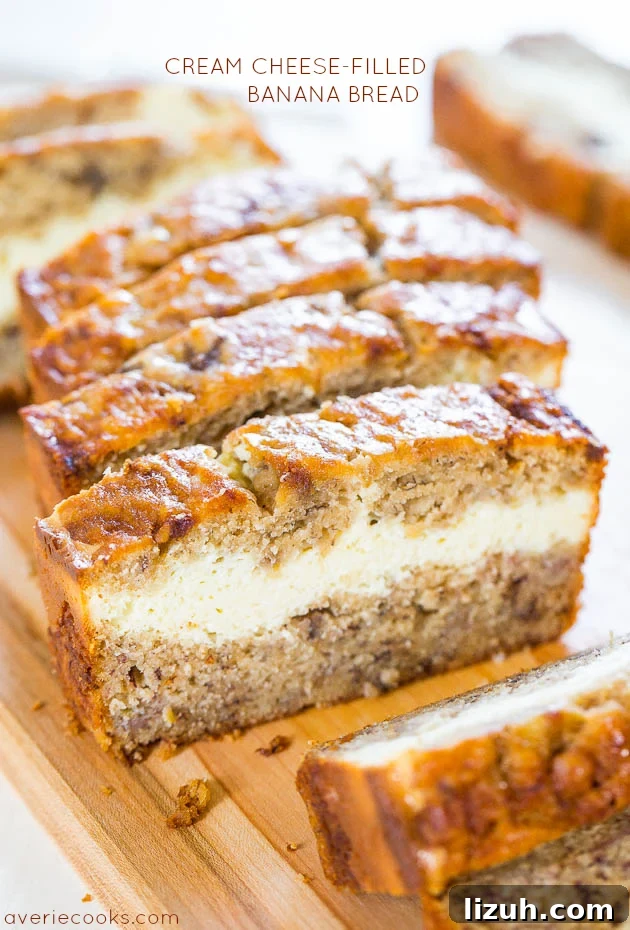 Cream Cheese-Filled Banana Bread sliced on a cutting board. 
