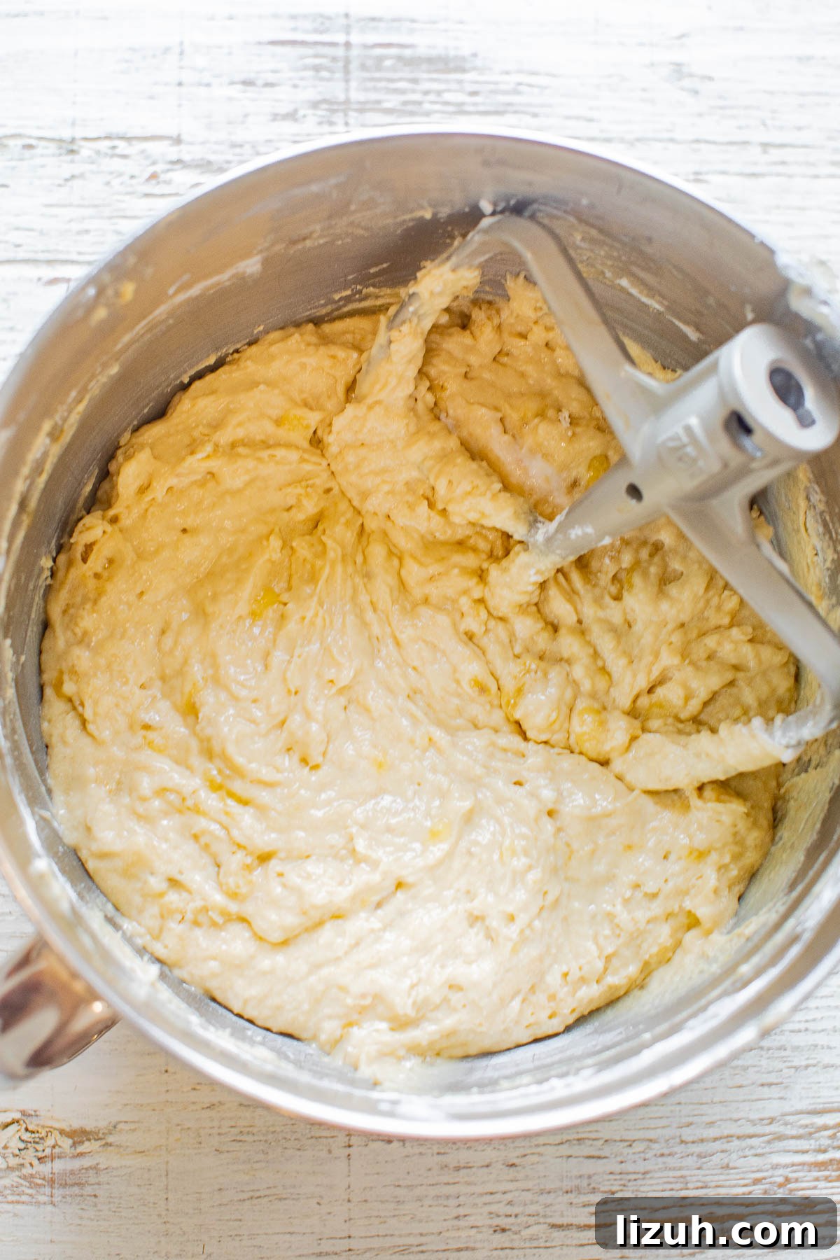 Banana cake batter in a stand mixer bowl. 