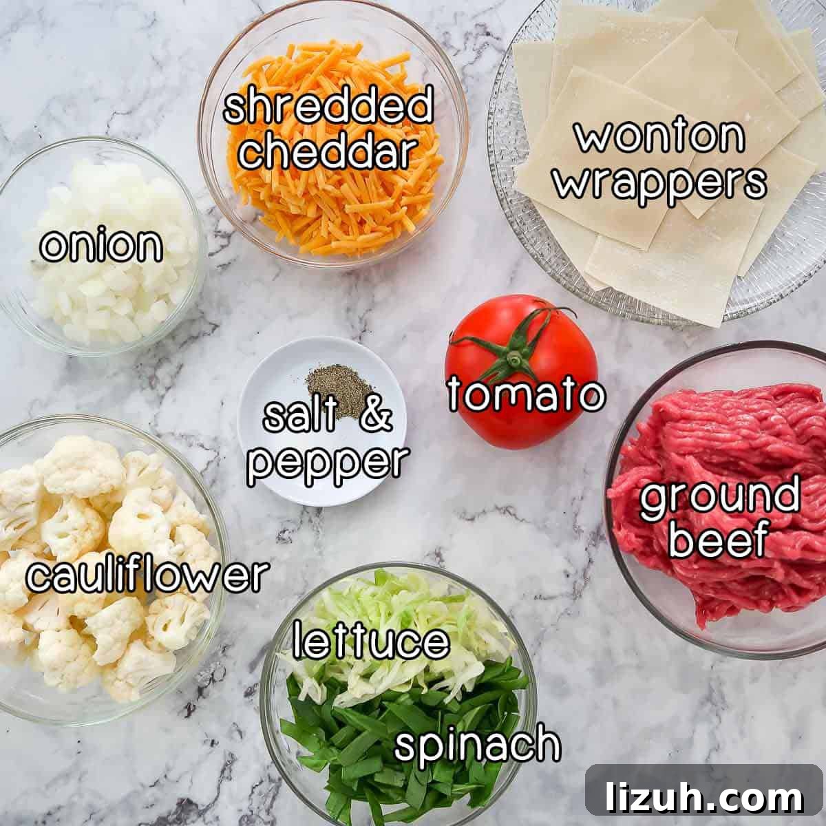 Crispy Wonton Cheeseburger Cups — Bite-Sized Party Sliders 3 Overhead shot of ingredients- wonton wrappers, shredded cheddar cheese, onion, tomato, ground beef, lettuce, spinach, cauliflower, salt, and pepper.