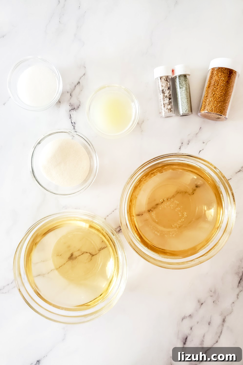 Champagne jello shot ingredients on a white marble background.