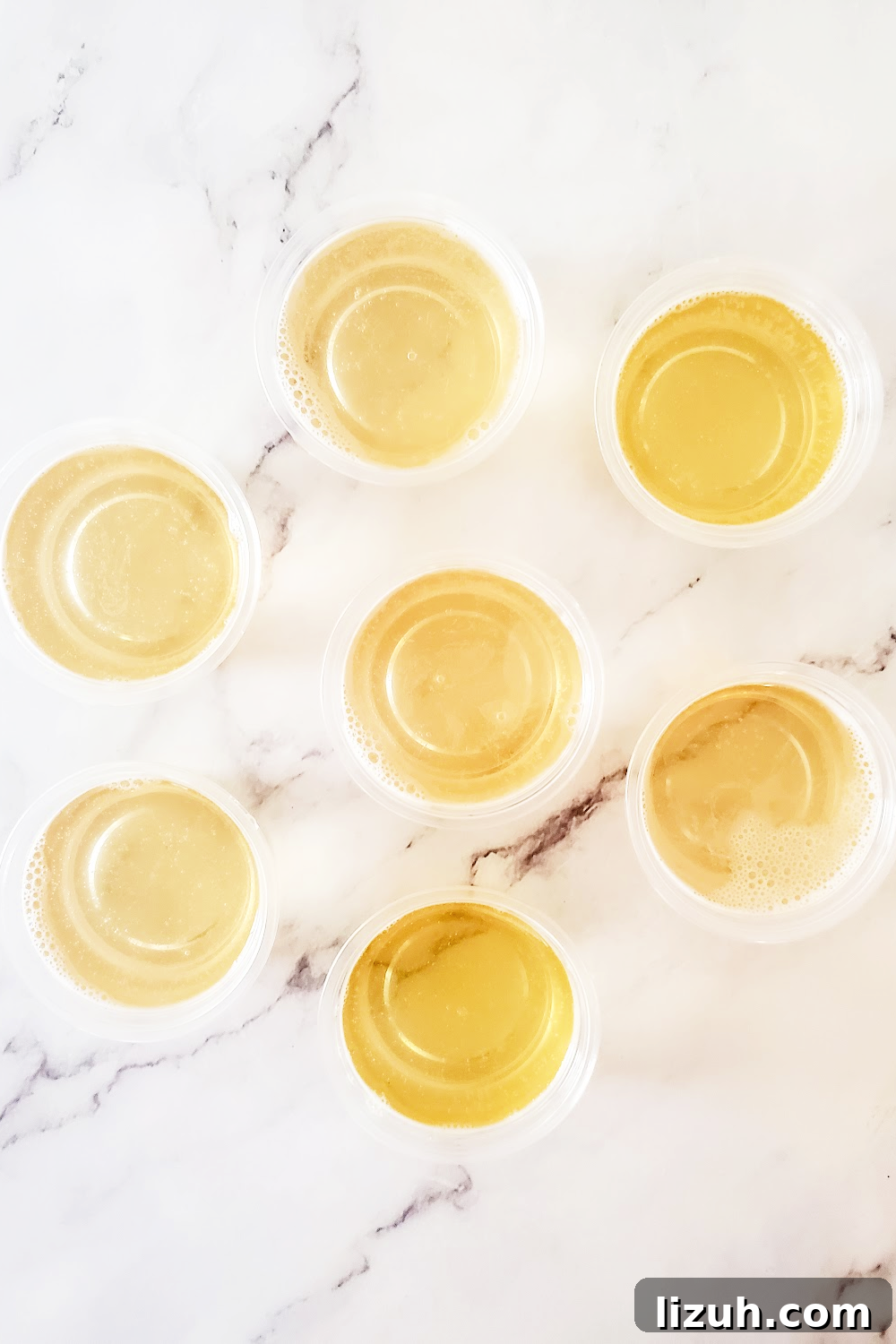 Adding the champagne mixture to the jello shot cups