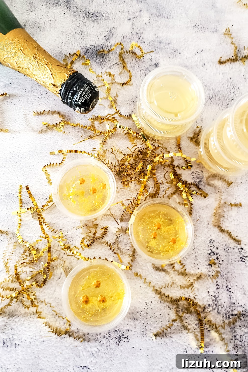 Stacked champagne jello shots with gold stars.