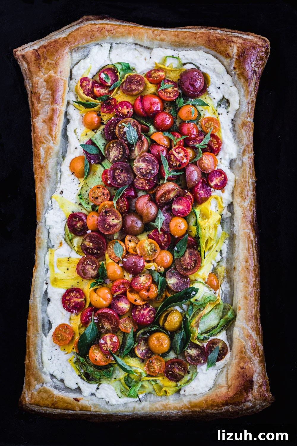 Lemony Ricotta Tomato Tart with Flaky Puff Pastry Crust 4 Rainbow tomato puff pastry tart with summer squash ribbons and basil, freshly out of the oven.